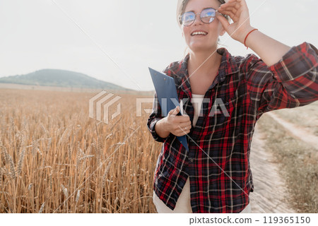 Smiling Woman in a Wheat Field with Clipboard 119365150