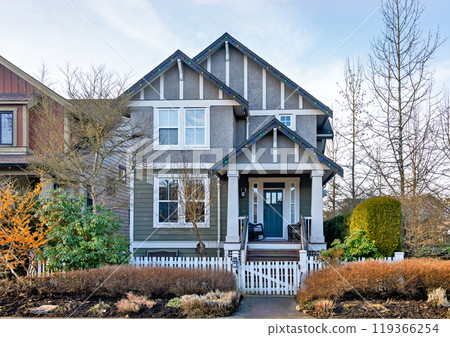 Average residential house decorated with Christmas lights on winter season Average residential house decorated with Christmas lights on winter season 119366254