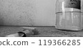 Glass Bottle with Sulfuric Acid Solution Against a Textured Wall 119366285
