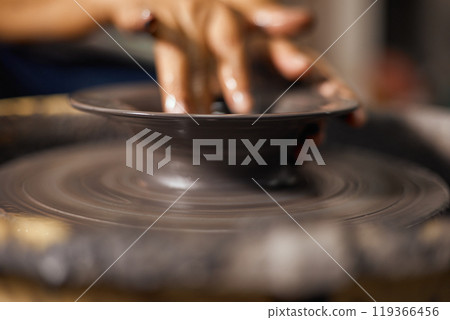 Hands of craftsman artist working on pottery wheel Hands of craftsman artist working on pottery wheel 119366456