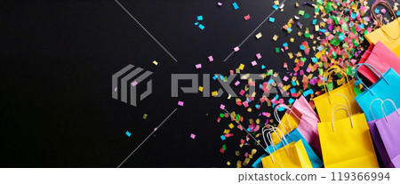 Colorful shopping bags celebrating on black background with confetti 119366994