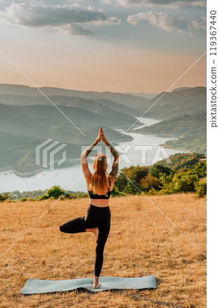 Woman Doing Yoga on Mountain River Background Woman Doing Yoga on Mountain River Background 119367440