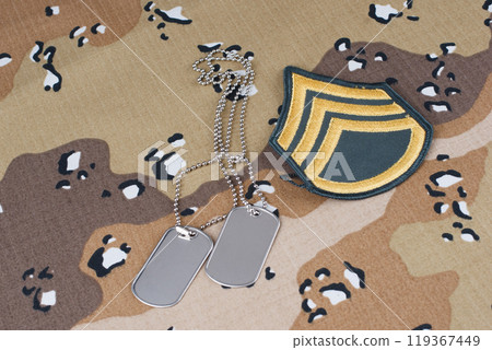 US ARMY Sergeant rank patch and dog tags on desert camouflage uniform US ARMY Sergeant rank patch and dog tags on desert camouflage uniform 119367449
