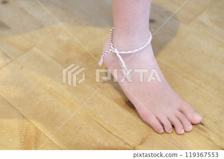 A friendship bracelet on the right ankle 119367553