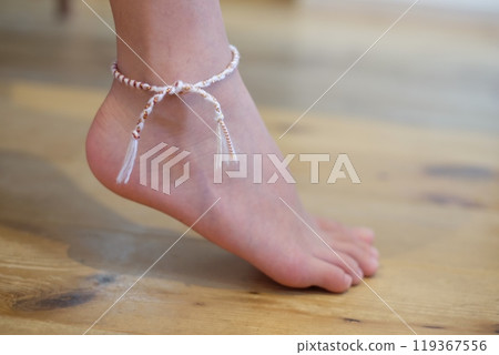 A friendship bracelet on the right ankle 119367556