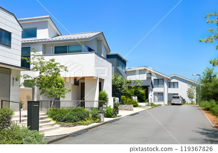 A refreshing residential area with rows of white houses and blue skies A refreshing residential area with rows of white houses and blue skies 119367826