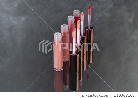 Lip gloss with applicator in light tubes. Cosmetic accessories. Lip gloss with applicator in light tubes. Cosmetic accessories. 119368165