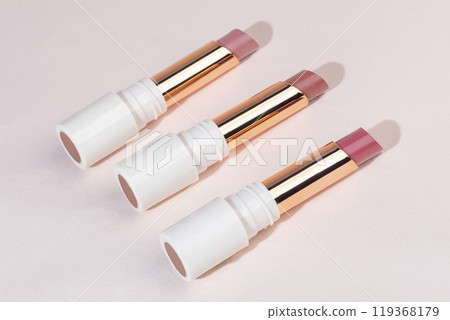colored lipstick in light tubes. Cosmetic accessories. 119368179