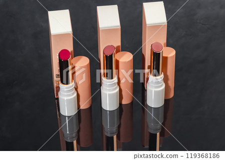 colored lipstick in light tubes. Cosmetic accessories. 119368186