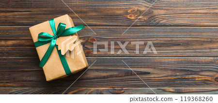 wrapped christmas or other holiday handmade present in paper with colored ribbon. Present box, decoration of gift on colourfull table, top view with copy space wrapped christmas or other holiday handmade present in paper with colored ribbon. Present box, decoration of gift on colourfull table, top view with copy space 119368260