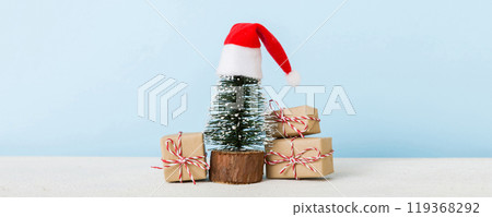 Christmas composition. Gifts, small tree, branches and craft DIY decorations on white background. New year concept. Christmas home decoration Flat lay, top view, copy space 119368292