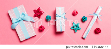 Top view of Christmas decorations on pink background. New Year holiday concept with copy space Top view of Christmas decorations on pink background. New Year holiday concept with copy space 119368333