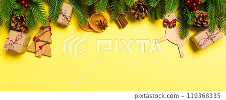 Top view of Christmas decorations on yellow background. New Year holiday concept with copy space 119368335