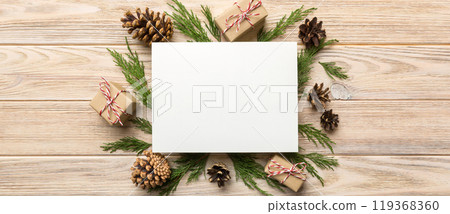 Flat lay Christmas composition. square Paper blank, pine tree branches, christmas decorations on Colored background. Top view, copy space for text Flat lay Christmas composition. square Paper blank, pine tree branches, christmas decorations on Colored background. Top view, copy space for text 119368360