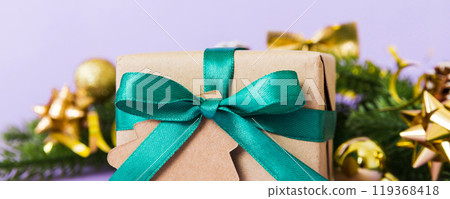 New Year Christmas mood, gift box, branches of a christmas tree, New Year decorations on a colored background 119368418