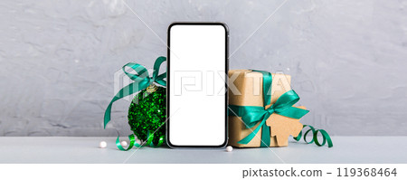 Digital phone mock up with rustic Christmas decorations for app presentation with empty space for you design. Christmas online shopping concept. Tablet with copy space on colored background 119368464