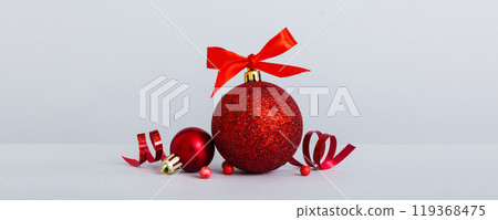Christmas ball on colored background. decoration bauble with ribbon bow with copy space Christmas ball on colored background. decoration bauble with ribbon bow with copy space 119368475