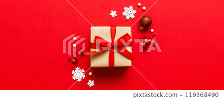 Top view Flat lay Christmas decorations and gift box on colored background with copy space. Christmas or Happy New Year composition 119368490