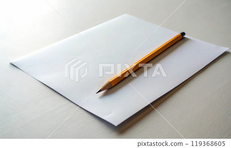 A yellow graphite pencil is lying on an empty piece of paper A yellow graphite pencil is lying on an empty piece of paper 119368605