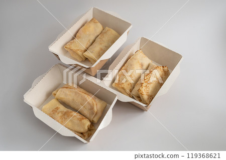 Three takeout boxes filled with neatly folded crepes, Three takeout boxes filled with neatly folded crepes, 119368621