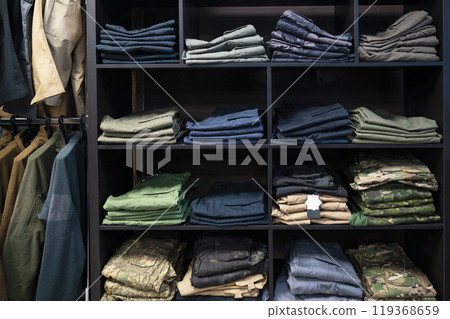 Folded Tactical Clothing and Military Uniforms on Shelves Folded Tactical Clothing and Military Uniforms on Shelves 119368659