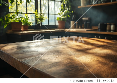 A rustic wooden kitchen island lit by sunlight, surrounded by potted plants and large windows 119369018