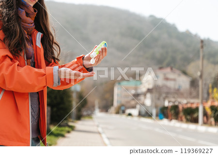 A woman applies an antibacterial antiseptic hand gel to disinfect and clean her hands. Copy space. Concept of influenza virus, coronavirus epidemic and infectious diseases A woman applies an antibacterial antiseptic hand gel to disinfect and clean her hands. Copy space. Concept of influenza virus, coronavirus epidemic and infectious diseases 119369227