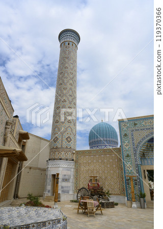 Minaret, mosque and courtyard, buiildings with traditional Uzbek mosaics in Samarkand, Uzbekistan Minaret, mosque and courtyard, buiildings with traditional Uzbek mosaics in Samarkand, Uzbekistan 119370366