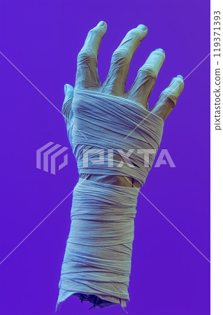 A hand reaches upward, wrapped in bandages against a vivid purple hue 119371393