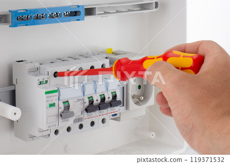 Electrician Adjusting Modern Circuit Breakers 119371532