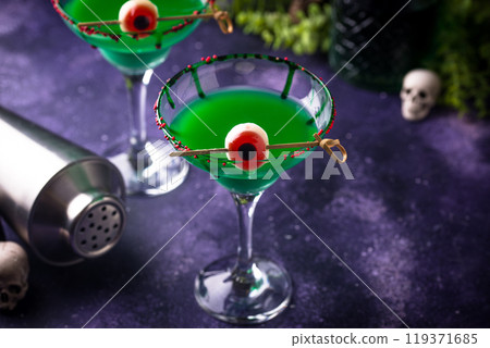 Eerie green halloween cocktail with eyeballs Eerie green halloween cocktail with eyeballs 119371685