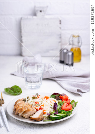 Grilled chicken breast with rice 119371694