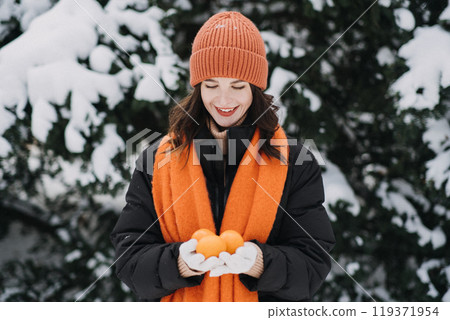 Woman holding citrus fruits in snow, winter nourishment with vibrant color, mindful living, nature, seasonal wellness Woman holding citrus fruits in snow, winter nourishment with vibrant color, mindful living, nature, seasonal wellness 119371954