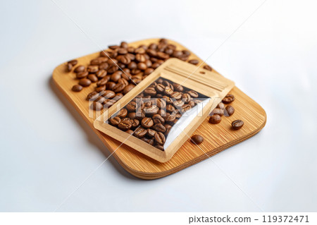 Roasted coffee beans visible through a die cut window in eco friendly brown paper packaging on light background. Rich texture and color of delicious drink 119372471