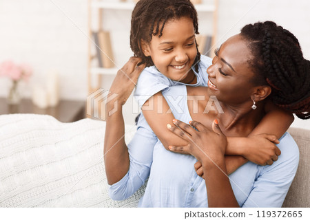 Happy Childhood. Black woman and little girl hugging, spending time together. Free space 119372665