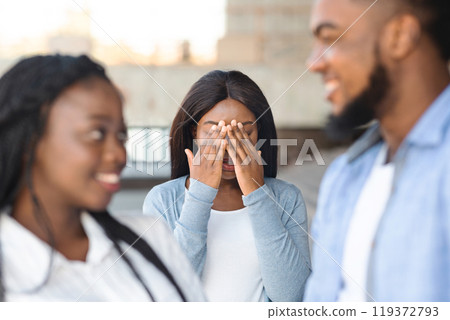 Unrequited Love Concept. Desperate african american girl jealous to her dating friends, covering her face with hands, envy about their relations 119372793