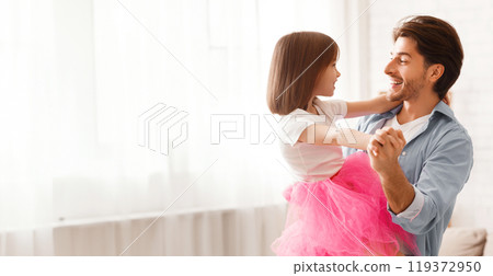 Cheery dad dancing with his little princess daughter, home background Cheery dad dancing with his little princess daughter, home background 119372950