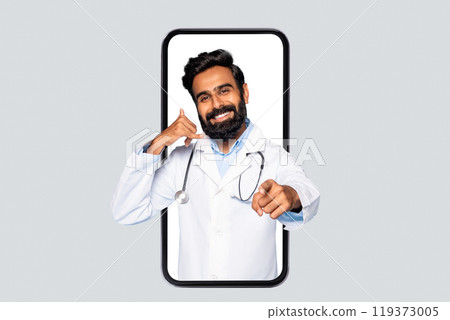 A smiling doctor in a white coat with a stethoscope is standing in a large smartphone. He is making a call me gesture with his left hand, and pointing at the viewer with his right. A smiling doctor in a white coat with a stethoscope is standing in a large smartphone. He is making a call me gesture with his left hand, and pointing at the viewer with his right. 119373005