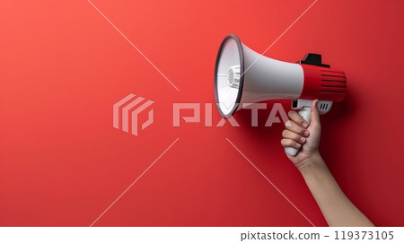 A hand holding a megaphone against red wall with copy space, AI 119373105