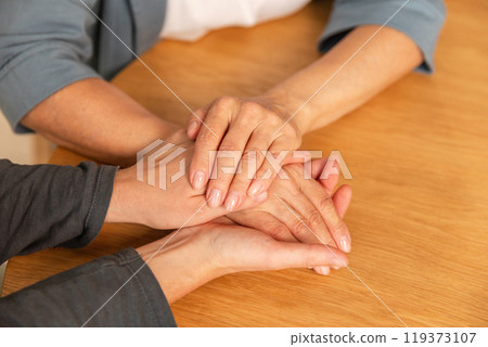 Happy family. Caring woman hands holding hands loving older woman mother. Grown up daughter and mom grandmother enjoying arm bonding. Family generations together at home. Family moment love and care 119373107