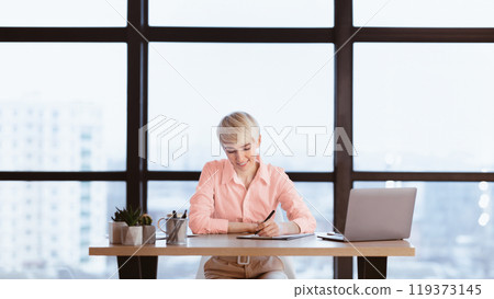 Dream Job. Businesswoman Taking Notes Writing Financial Report Sitting At Work Desk In Modern Office 119373145