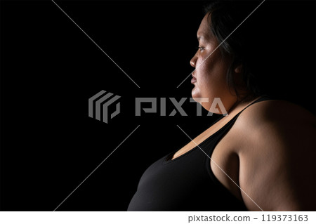 close-up of an overweight woman.increased risks of cardiovascular disease  119373163