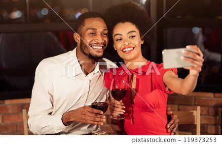 Valentine's Selfie. Happy African American Couple Making Self-Portrait On Smartphone Holding Wine Glasses Having Date In Restaurant 119373253