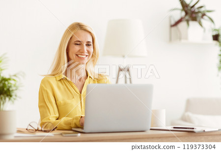Successful Mature Businesswoman Using Laptop, Working At Home Office Successful Mature Businesswoman Using Laptop, Working At Home Office 119373304