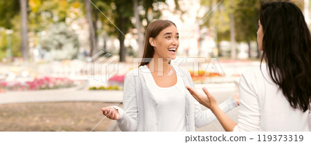 Happy Girl Meeting Female Friend Greeting And Talking Walking Outdoors In Park. Selective Focus 119373319