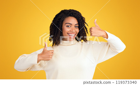 Human Reaction Concept. Black woman showing thumbs up isolated over yellow background. Copy space 119373340