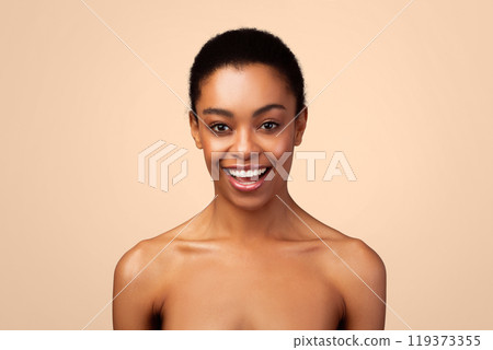 Portrait Of Happy Black Woman Posing Standing Shirtless Over Gray Background In Studio, Looking At Camera. Natural Female Beauty. Headshot Of Joyful African American Young Lady 119373355