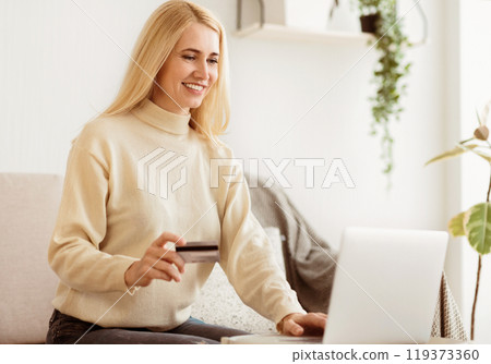 Happy Woman Doing Online Shopping At Home Using Laptop Computer, Free Space 119373360