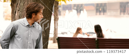 Suspicious Man Spying On Girls Stalking Them While They Talking Sitting In Park Suspicious Man Spying On Girls Stalking Them While They Talking Sitting In Park 119373417