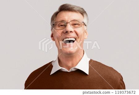 Lol. Elderly Man Laughing Out Loud Looking At Camera Posing In Studio Over Gray Background. 119373672
